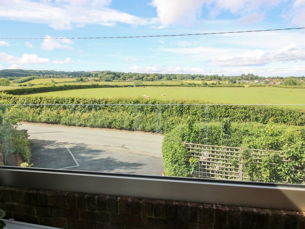 A view of a field and road at Plum Hill in Morda, near Oswestry