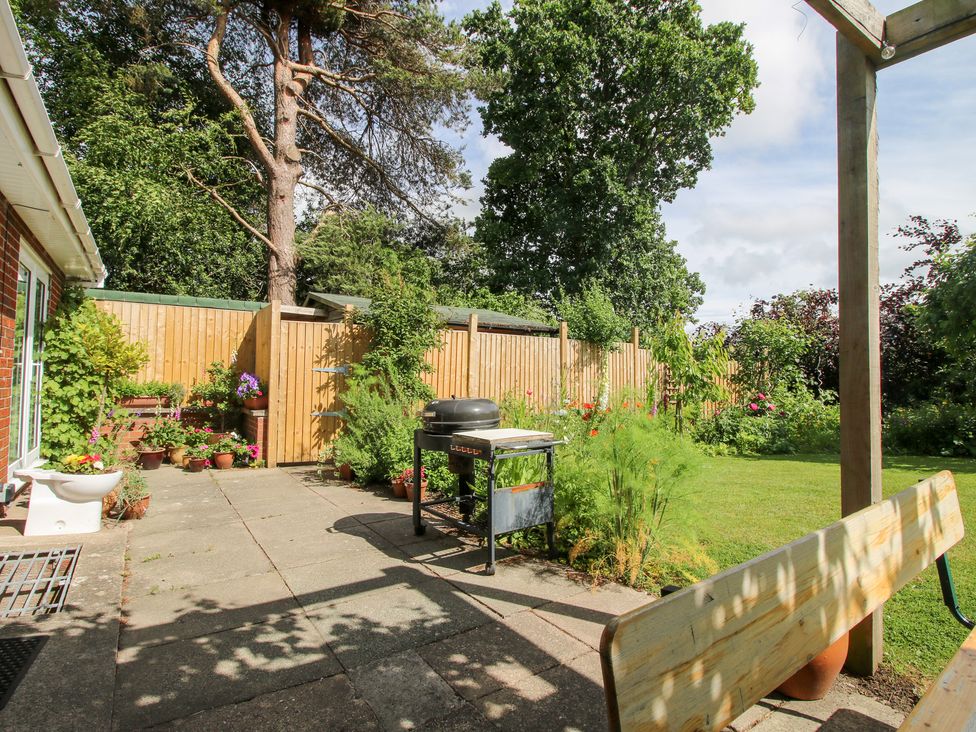 A garden with a grill and flower pots at Plum Hill, Morda, near Oswestry