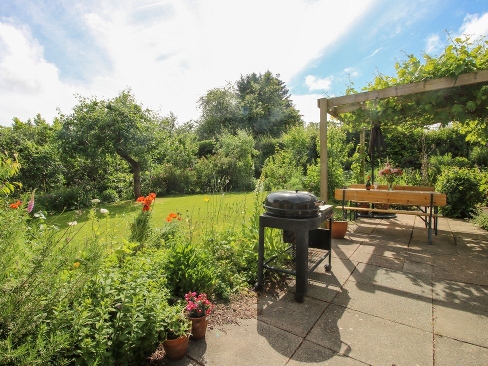 A garden with a grill and seating area at Plum Hill in Morda, near Oswestry