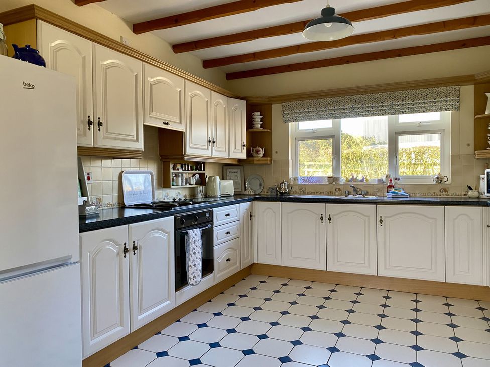 A kitchen with cabinets, sink, and oven at Betty's Farm Cottage in Lack near Ederney, County Fermanagh