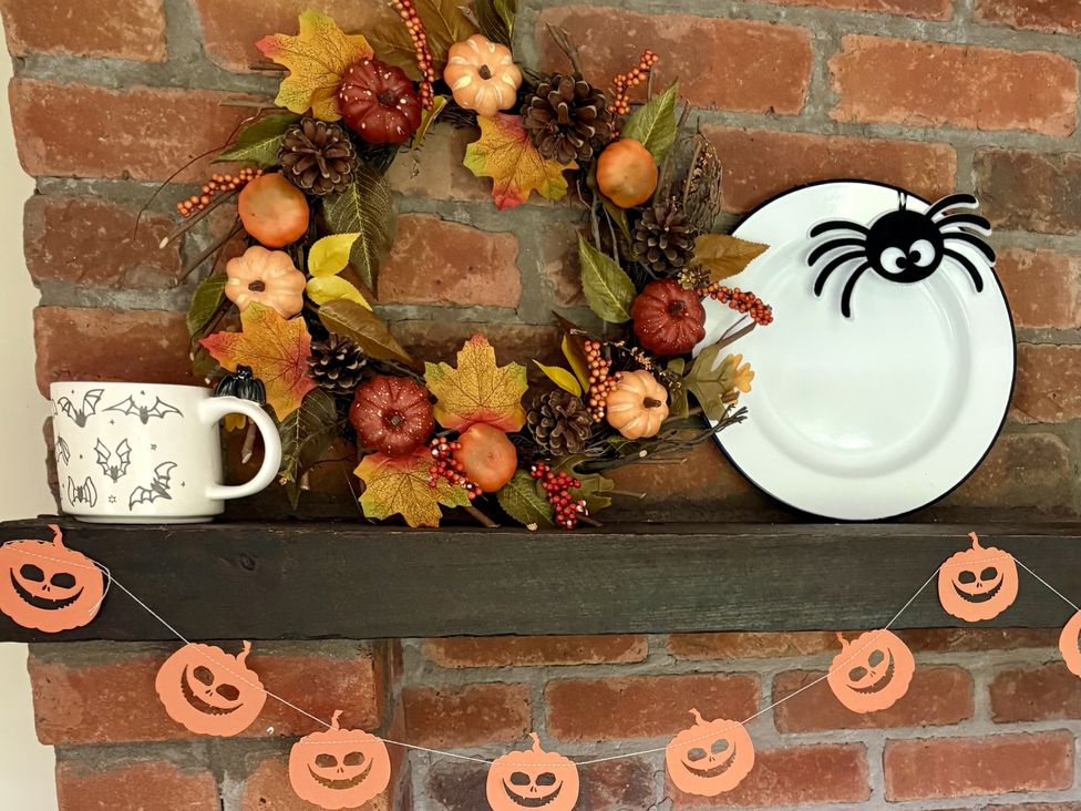 A decorative shelf with a wreath, mug, plate and pumpkin garland at Betty's Farm Cottage, Lack near Ederney, County Fermanagh