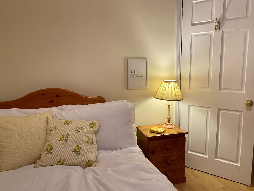 A bedroom with a bed and nightstand at Betty's Farm Cottage in Lack near Ederney, County Fermanagh
