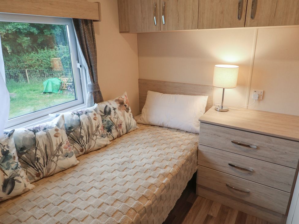 A bedroom with a bed and nightstand at The Hoot in Great Finborough near Stowmarket