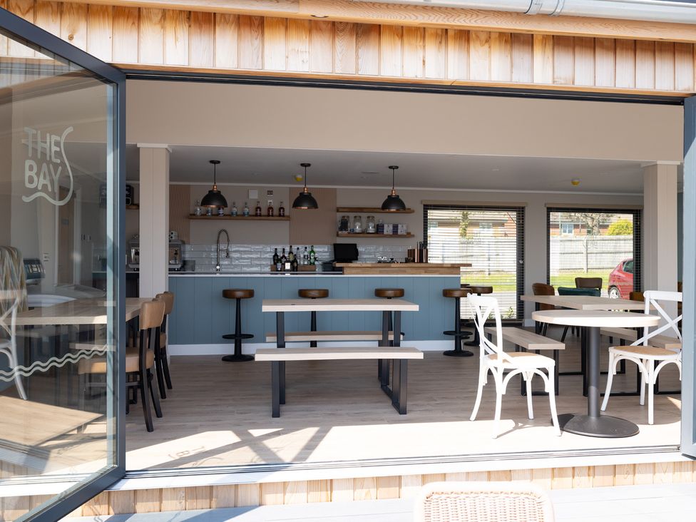 A bar area with tables and chairs at Lodge 65 at Riviera Bay Coastal Retreat Brixham