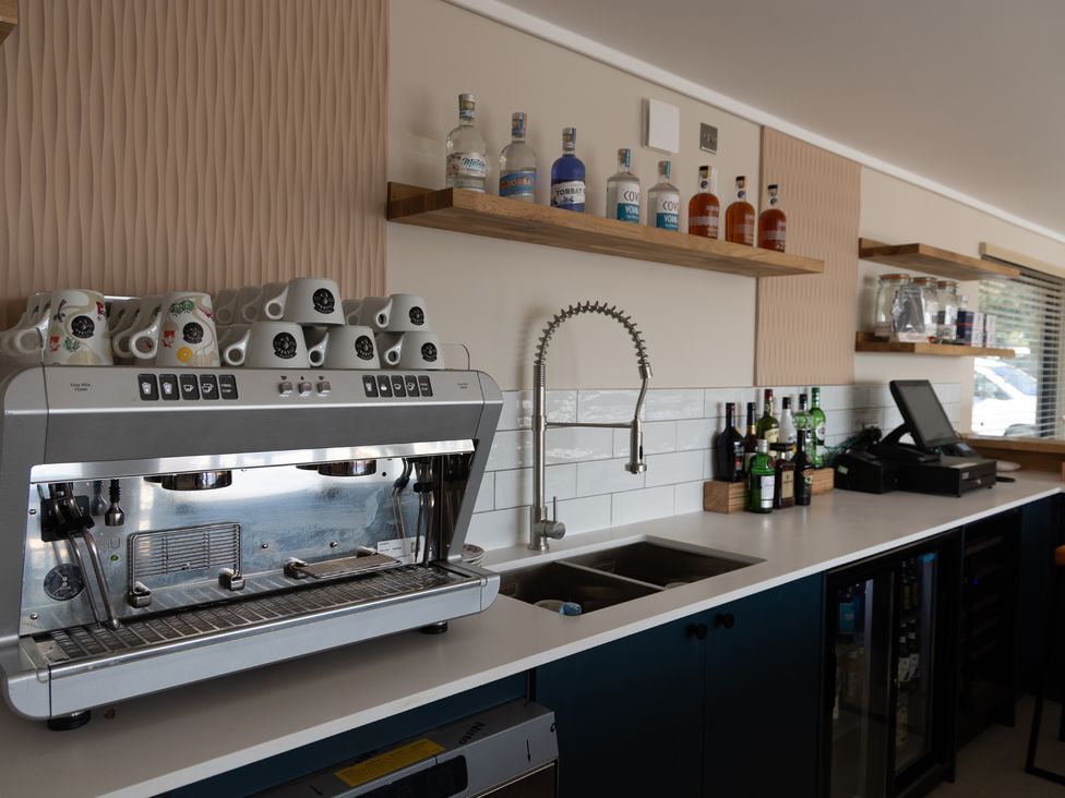 A kitchen with an espresso machine and bar equipment at Lodge 65 at Riviera Bay Coastal Retreat, Brixham