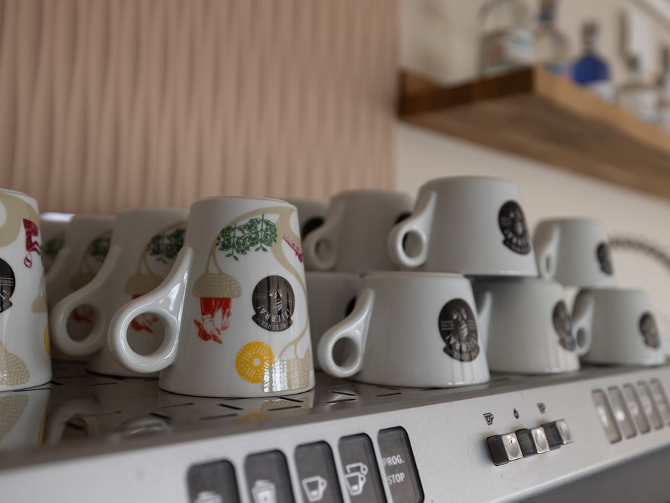 A set of decorative cups on a coffee machine at Lodge 65 at Riviera Bay Coastal Retreat, Brixham