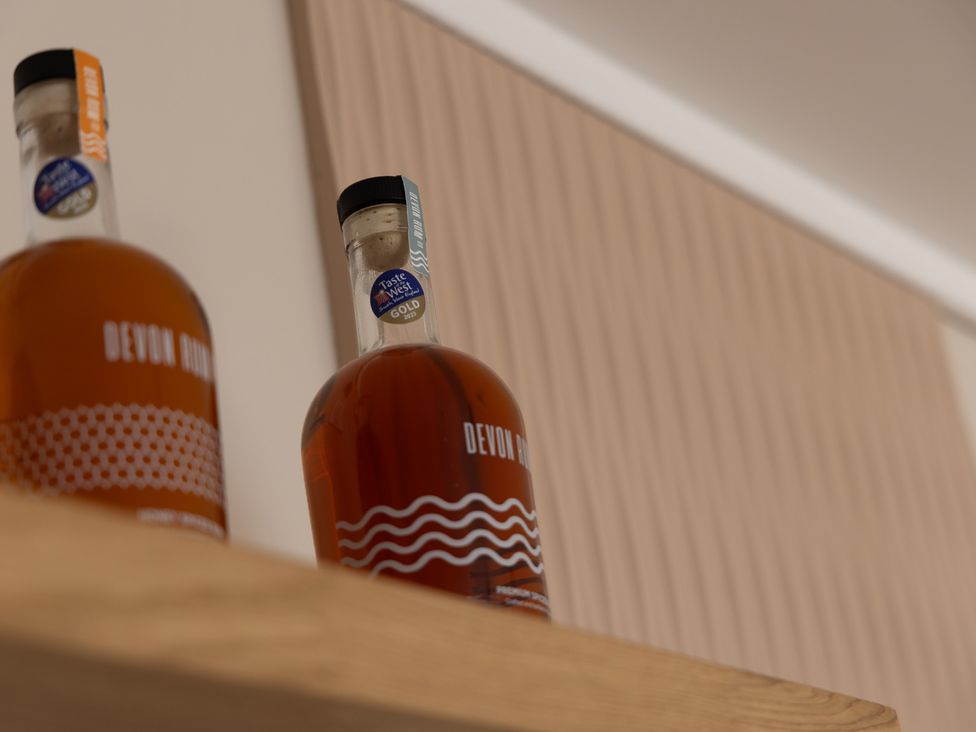 Two bottles of Devon rum on a shelf at Lodge 65 at Riviera Bay Coastal Retreat Brixham