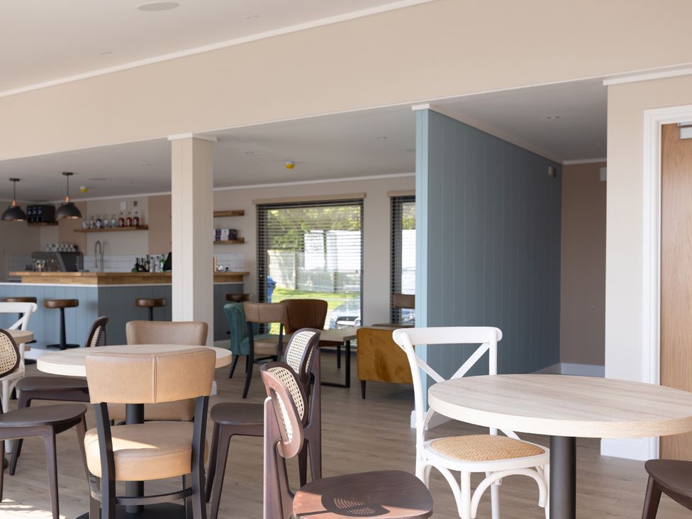 An indoor dining area with tables and chairs at Lodge 65 at Riviera Bay Coastal Retreat, Brixham
