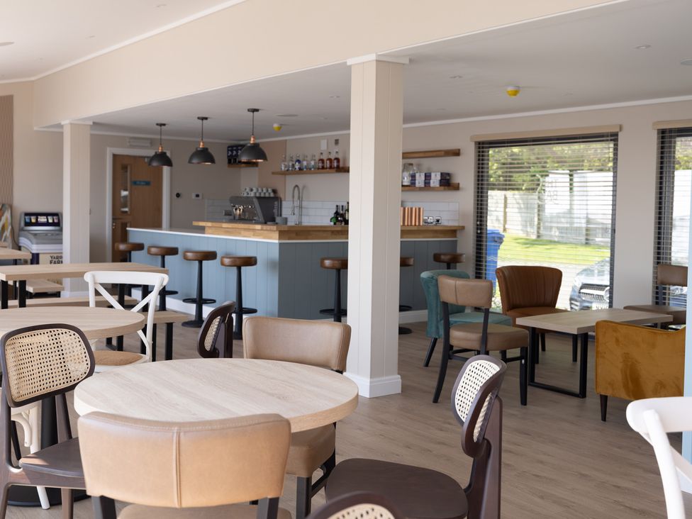 A dining room with tables and chairs at Lodge 65 at Riviera Bay Coastal Retreat Brixham