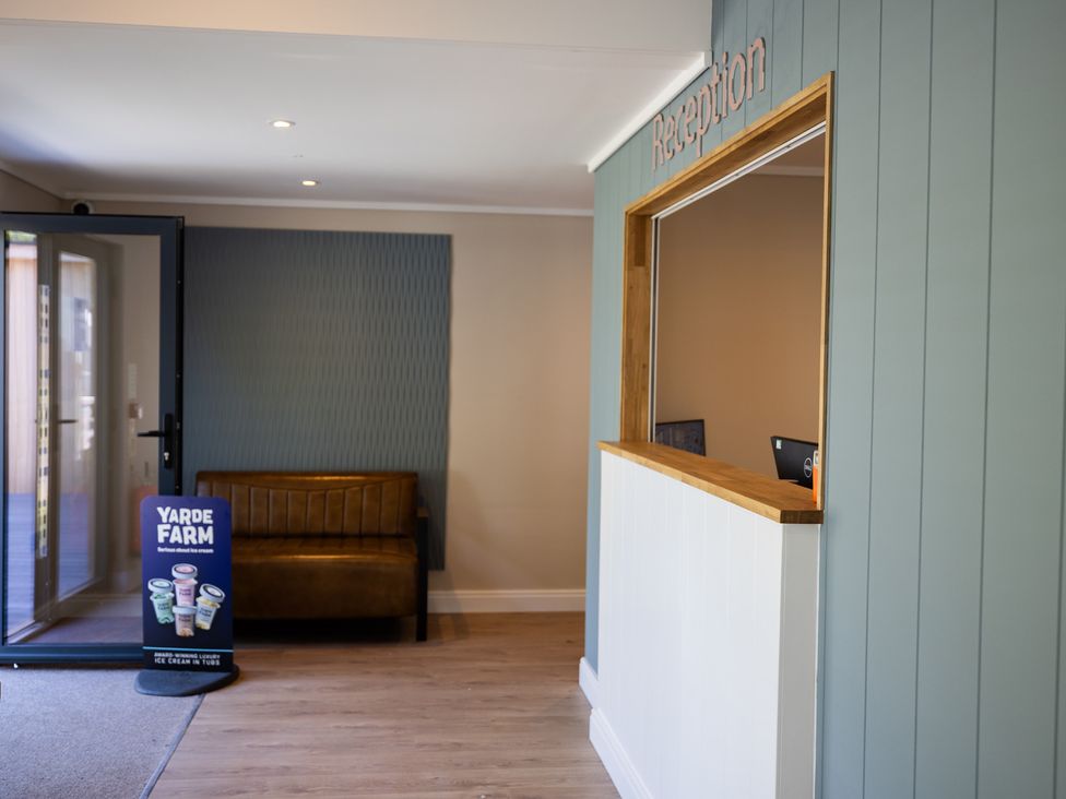 A reception area with a desk and seating at Lodge 65 at Riviera Bay Coastal Retreat Brixham