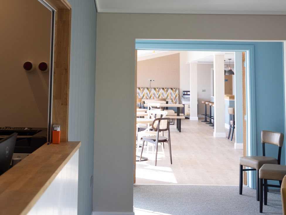 A dining area with tables and chairs at Lodge 65 at Riviera Bay Coastal Retreat Brixham