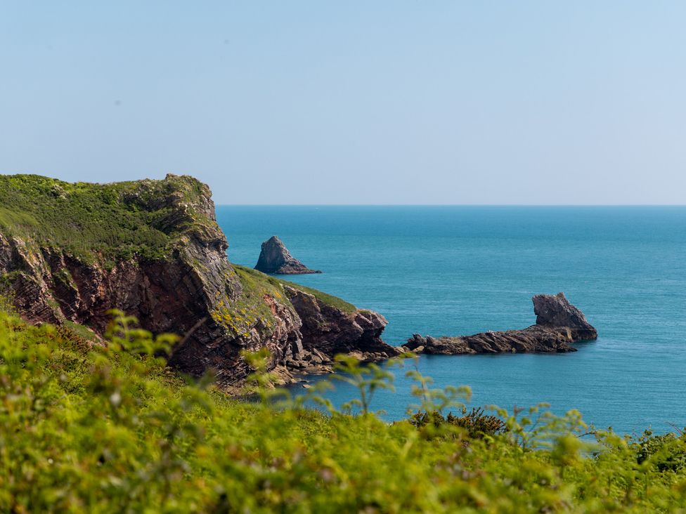 A coastal scene with cliffs and ocean at Lodge 65 at Riviera Bay Coastal Retreat Brixham