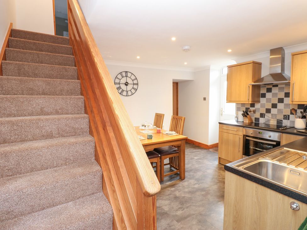 A kitchen with a dining table and chairs at Stoneleigh Cottage in Muker