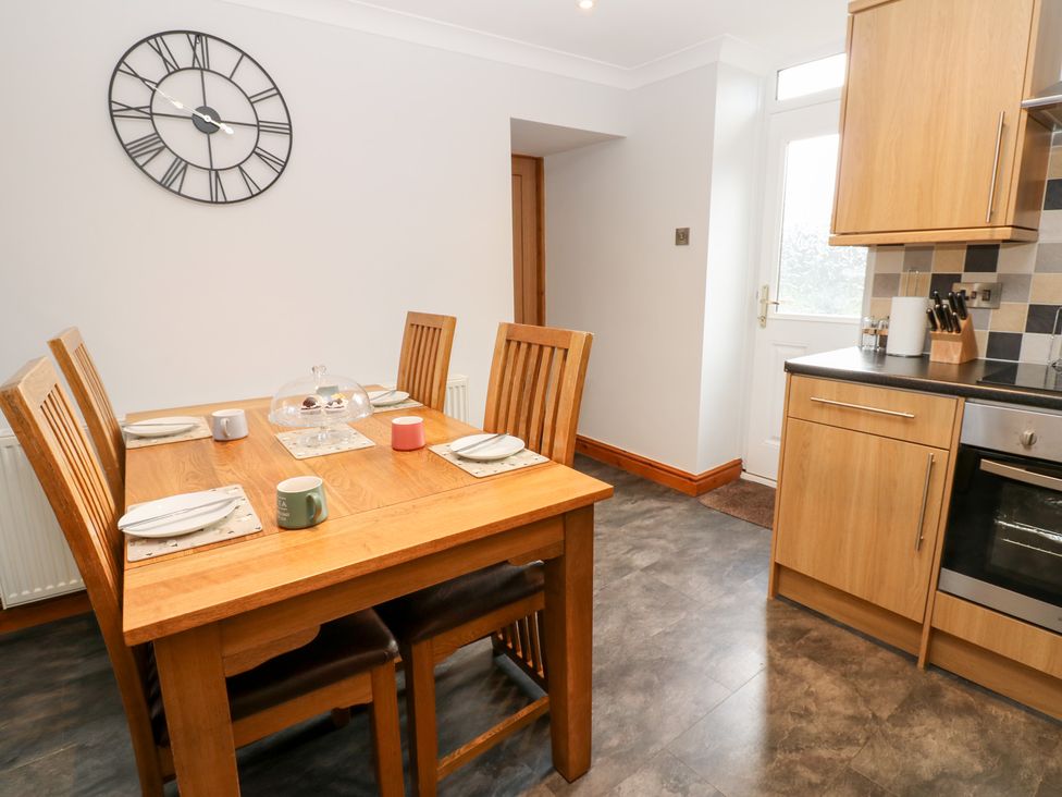 A dining room with a table and chairs at Stoneleigh Cottage in Muker