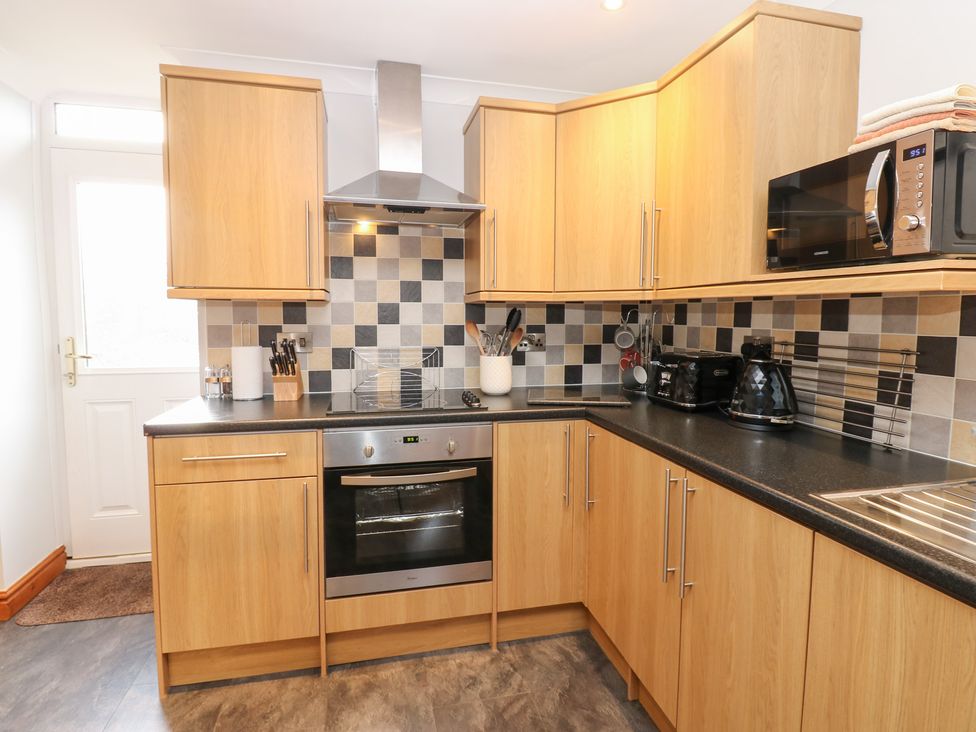 A kitchen with cabinets and appliances at Stoneleigh Cottage in Muker