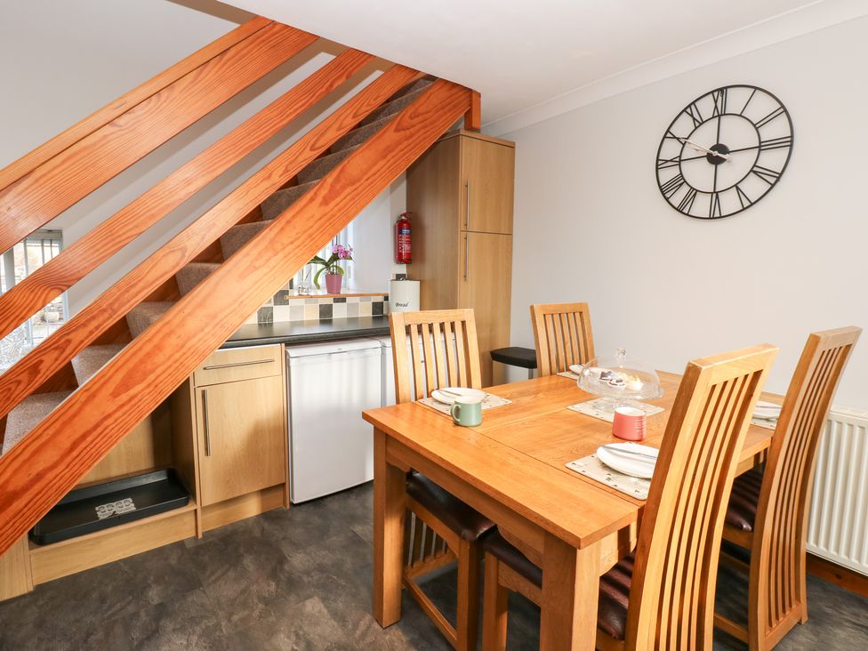 A dining room with a table and chairs at Stoneleigh Cottage in Muker