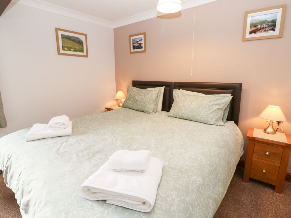 A bedroom with a double bed and bedside table at Stoneleigh Cottage in Muker