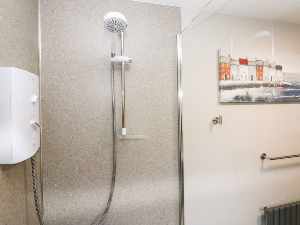 A shower with wall art and controls at Stoneleigh Cottage in Muker