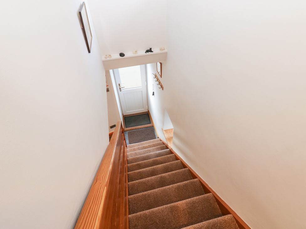 A staircase leading to a door at Stoneleigh Cottage in Muker