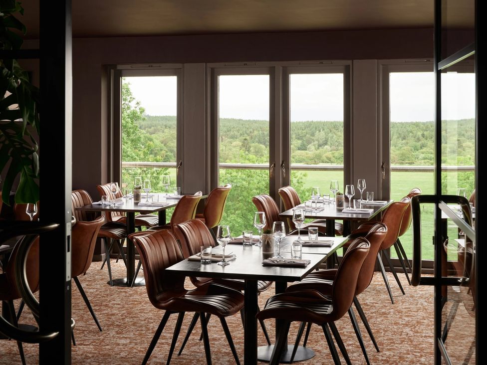 A dining room with tables and chairs at Squirrel Cottage in Penruddock