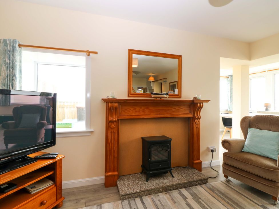 A living room with a television and fireplace at The Breakers in Newburgh, Aberdeenshire