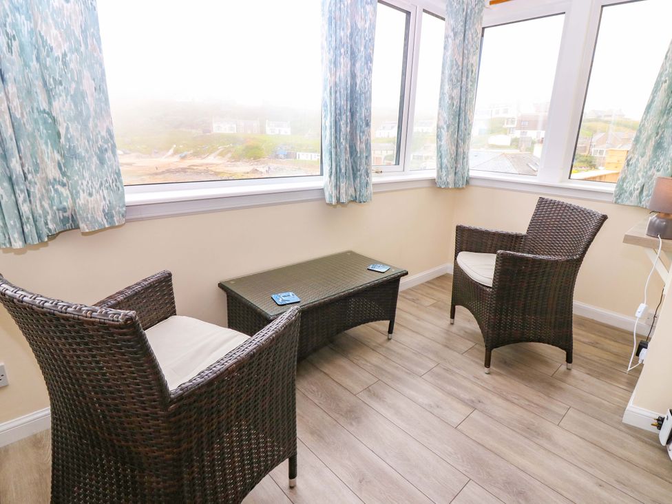 A conservatory with seating and a table at The Breakers in Newburgh, Aberdeenshire