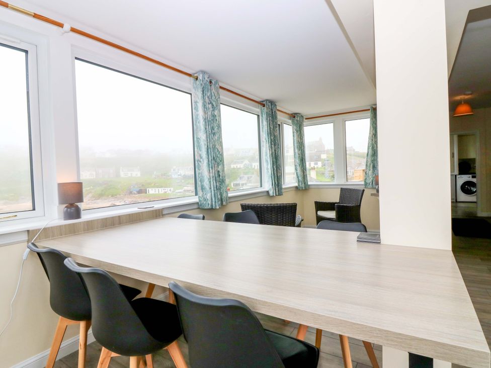 A dining room with a table and chairs at The Breakers in Newburgh, Aberdeenshire