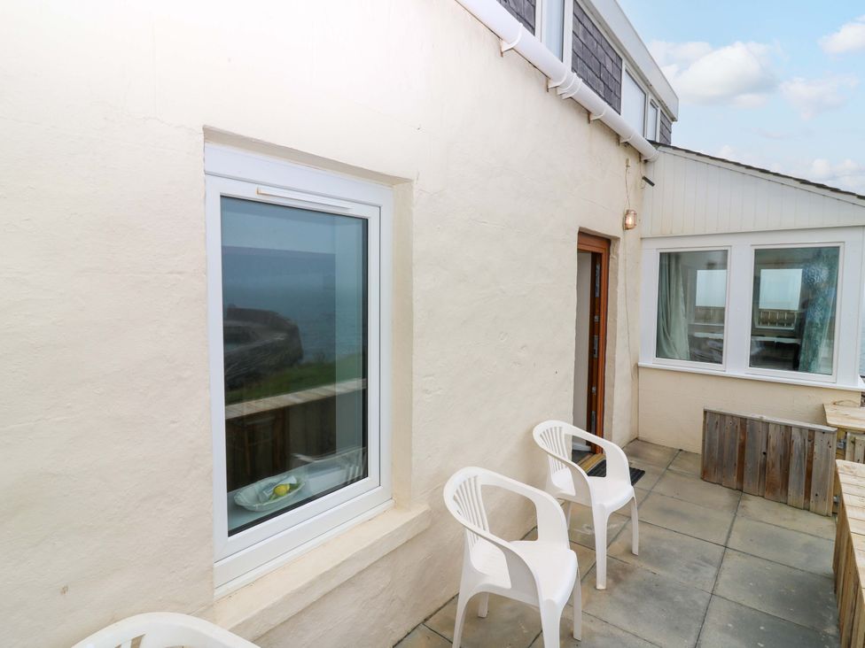 An outdoor area with chairs and a window at The Breakers in Newburgh, Aberdeenshire