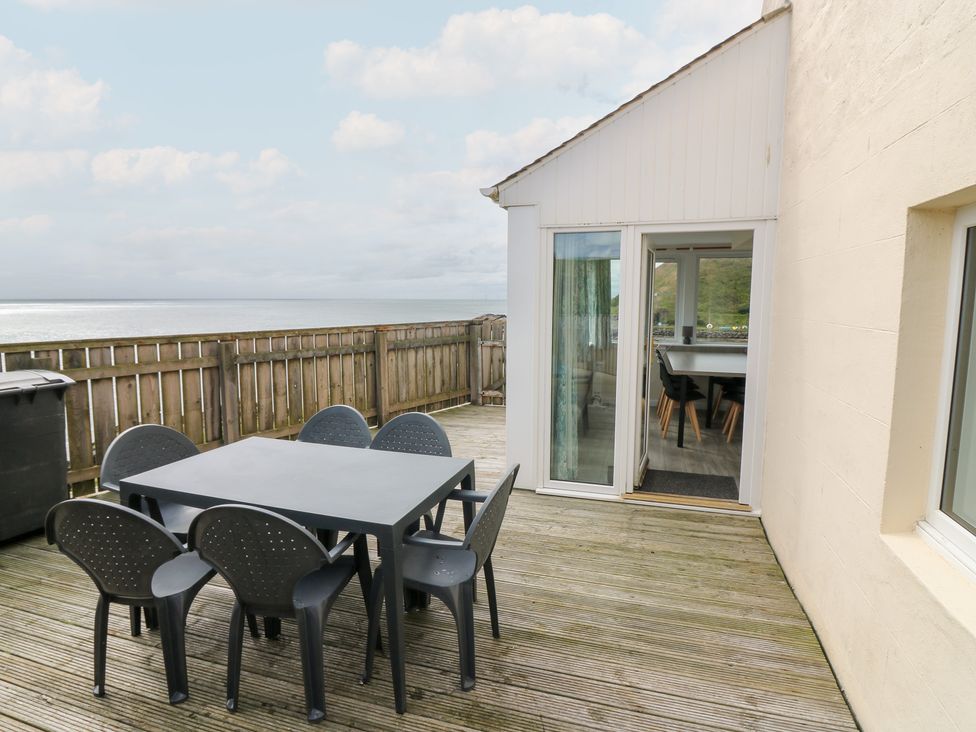 An outdoor dining area with a table and chairs at The Breakers in Newburgh, Aberdeenshire