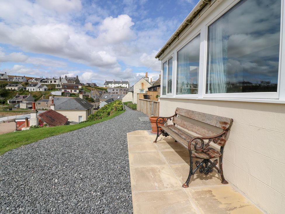 A garden with a bench and gravel pathway at The Breakers in Newburgh, Aberdeenshire