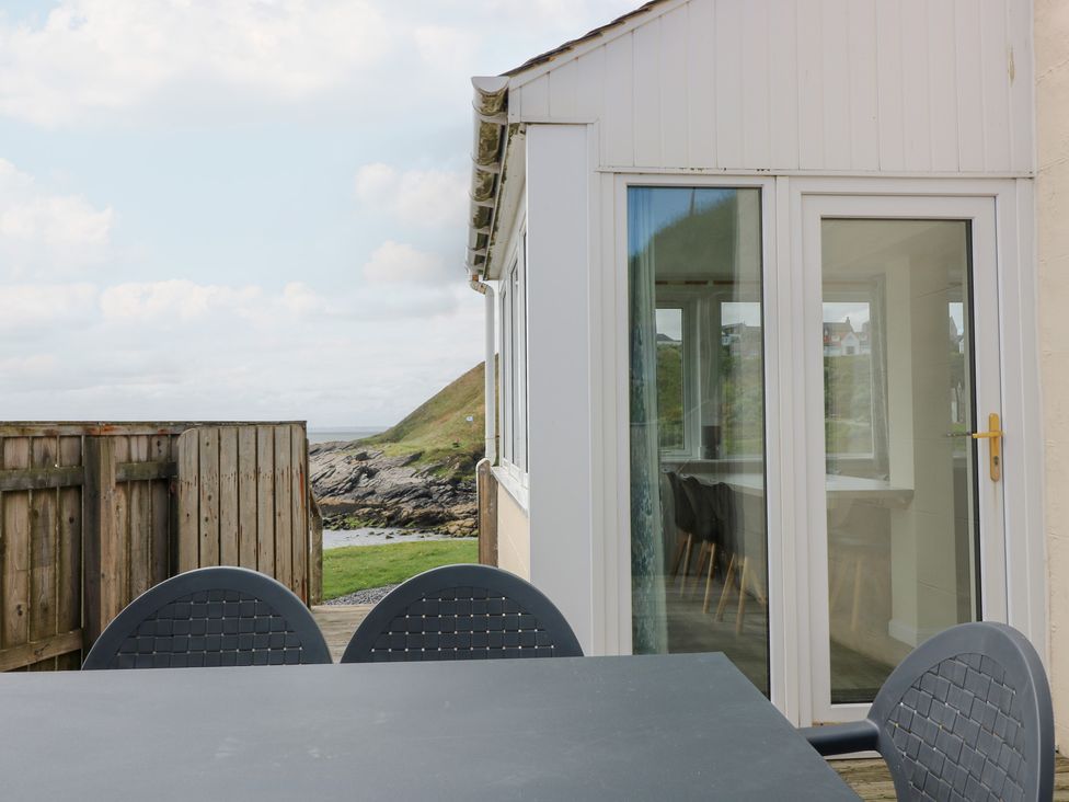 An outdoor area with a table and chairs at The Breakers in Newburgh, Aberdeenshire