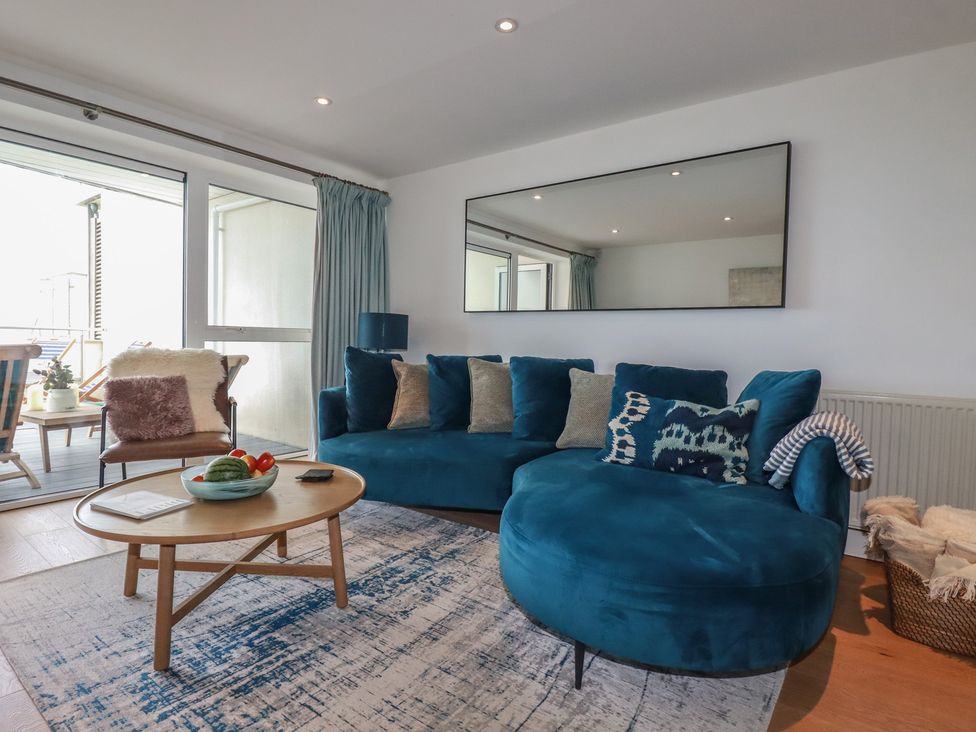 A living room with a sofa and coffee table at 4 Ocean Gate in Newquay