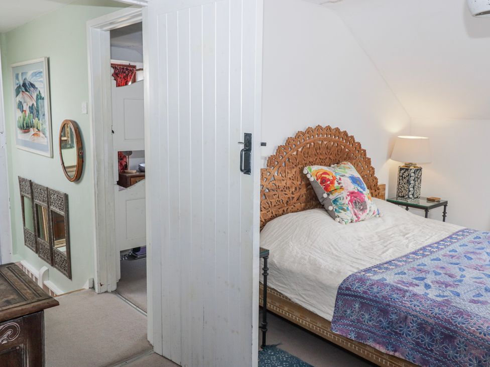 A bedroom with a bed and decorative elements at Pencestyll in Cardigan