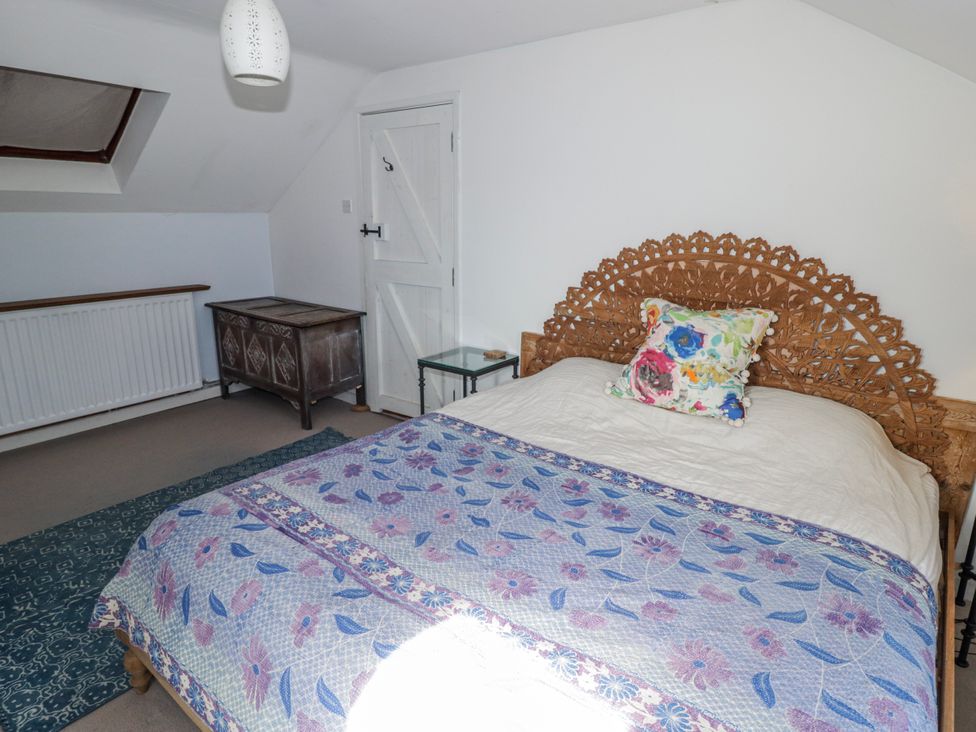 A bedroom with a bed and decorative chest at Pencestyll in Cardigan