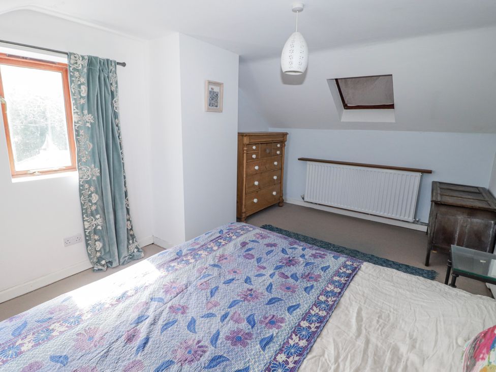 A bedroom with a bed and dresser at Pencestyll Cardigan