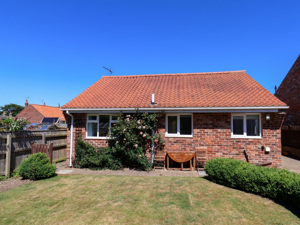 A house with windows and garden seating at Castelian in Flamborough