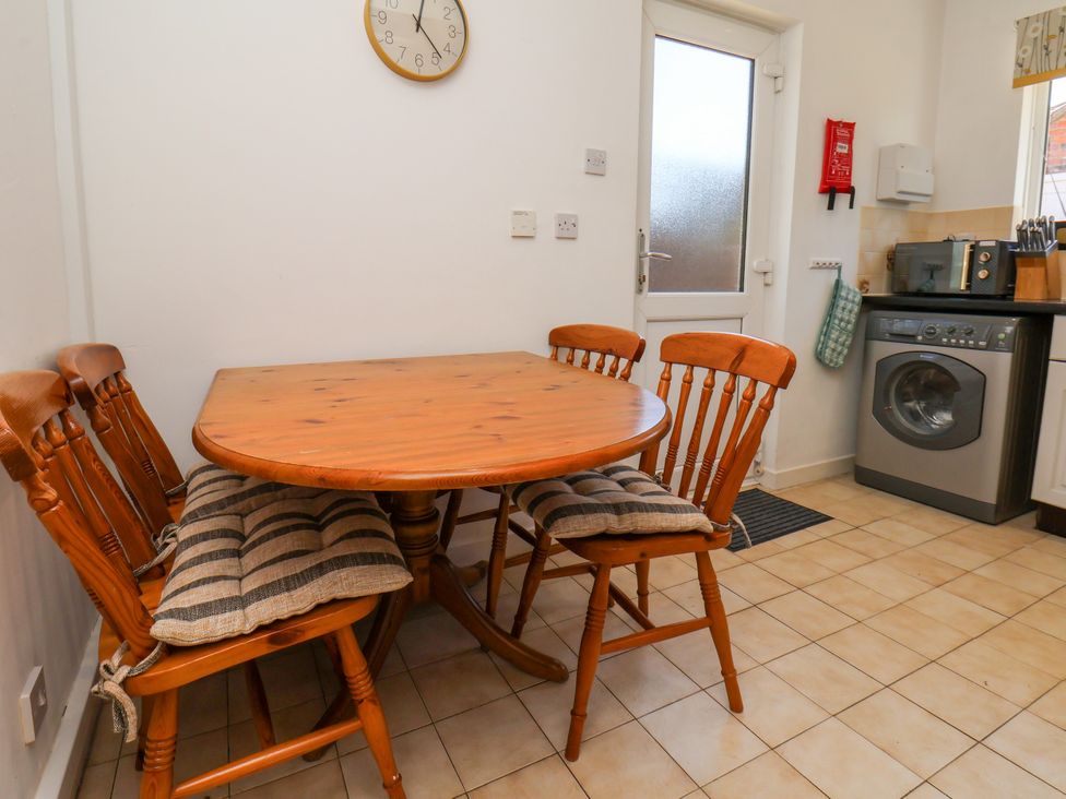 A kitchen with a round table and chairs at Castelian in Flamborough