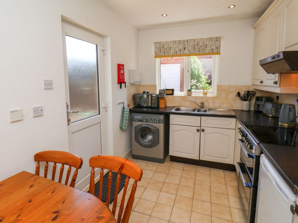 A kitchen with a table and chairs at Castelian in Flamborough