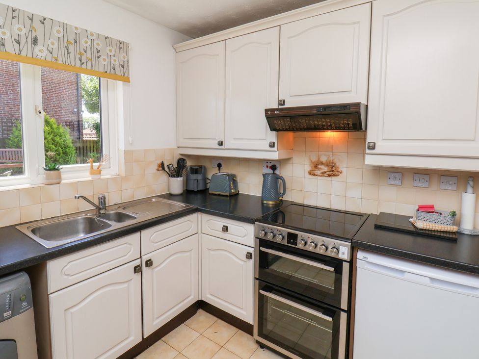 A kitchen with a sink and cooker at Castelian in Flamborough