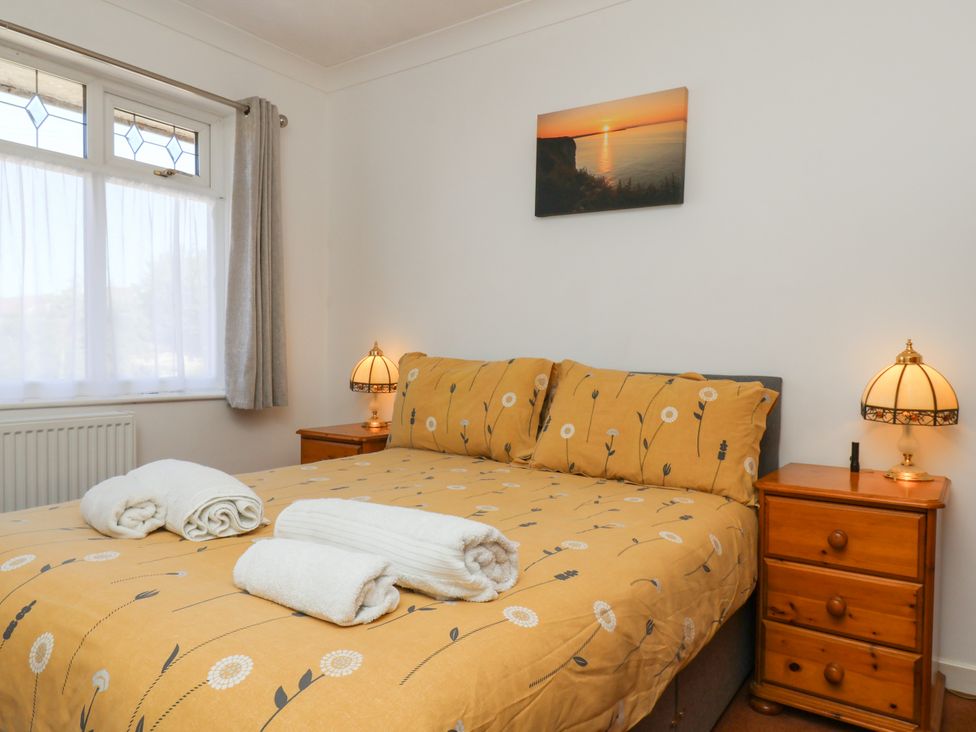 A bedroom with a bed and bedside tables at Castelian in Flamborough