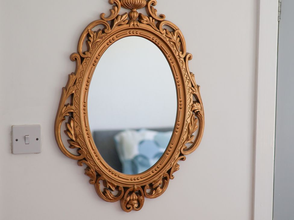 A decorative mirror on a wall at Castelian in Flamborough