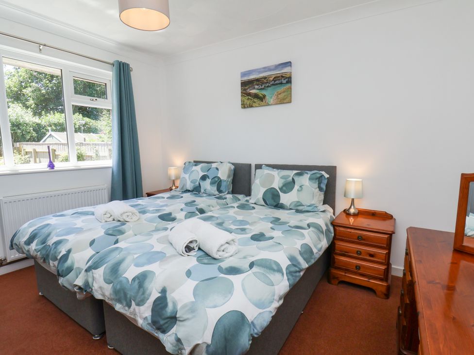A bedroom with a bed and side tables at Castelian in Flamborough