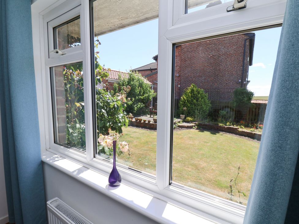 A window with a view of a garden at Castelian in Flamborough