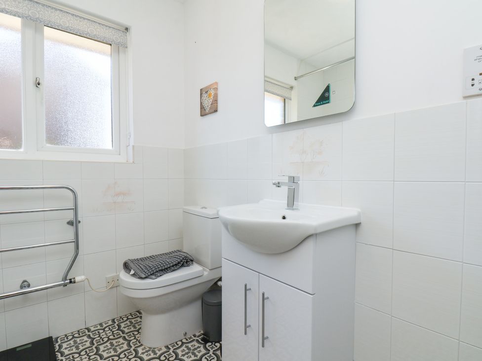 A bathroom with a toilet and wash basin at Castelian in Flamborough