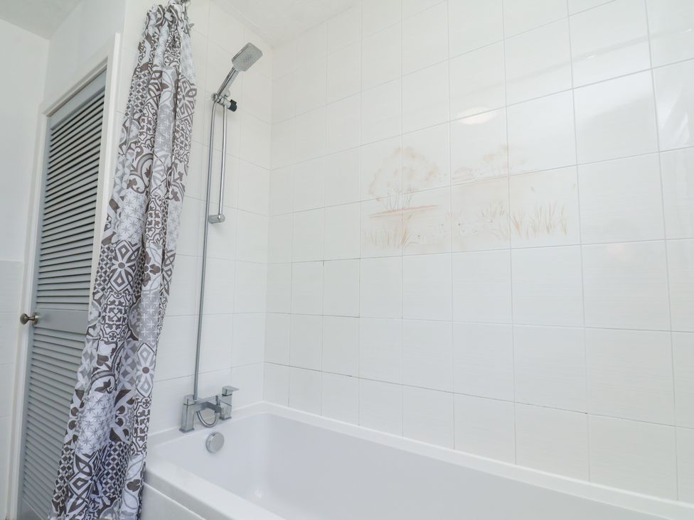 A bathroom featuring a bathtub and shower at Castelian in Flamborough