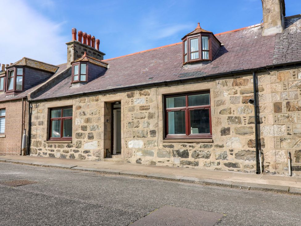 A stone house with windows and a front door at No.9 North St Fraserborough