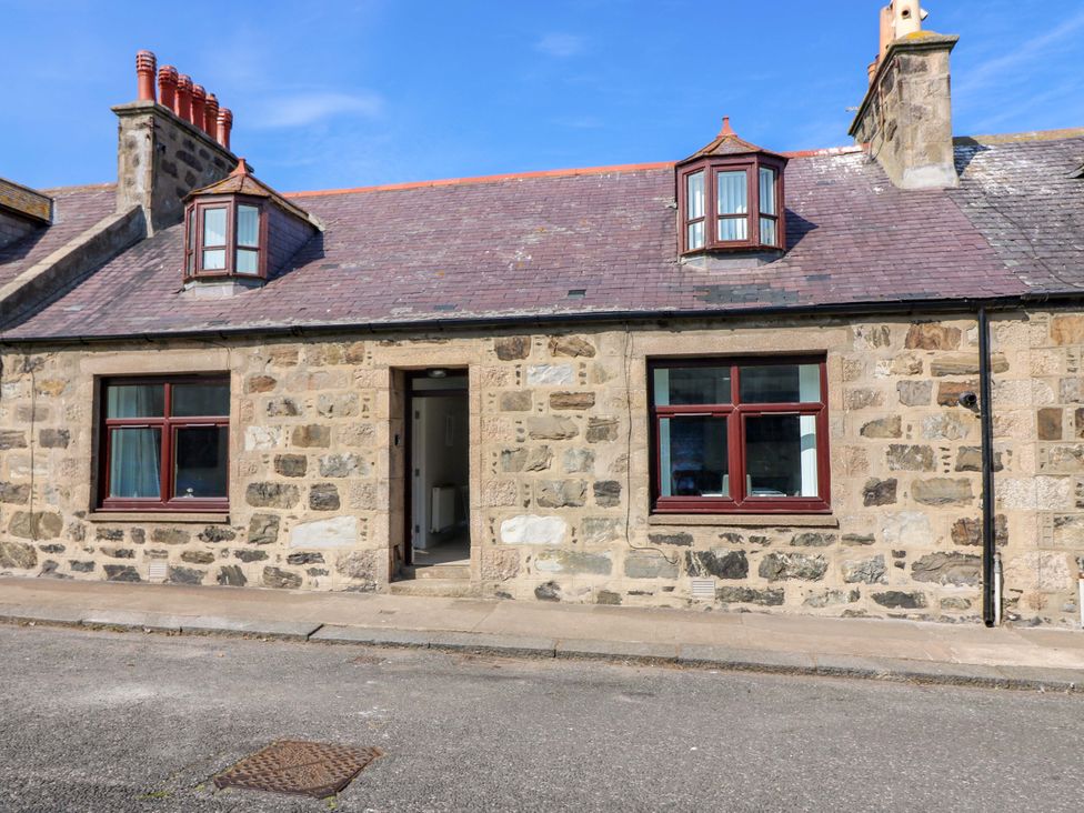A stone cottage with windows and doorway at No.9 North St Fraserburgh