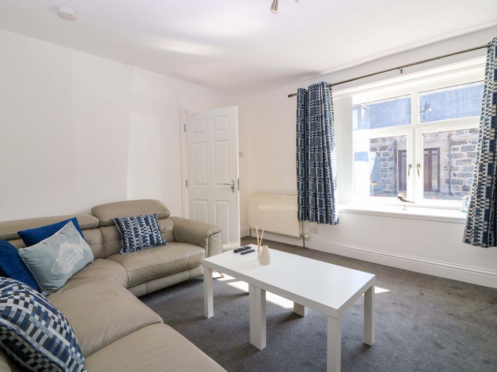 A living room with a sofa and coffee table at No.9 North St Fraserborough