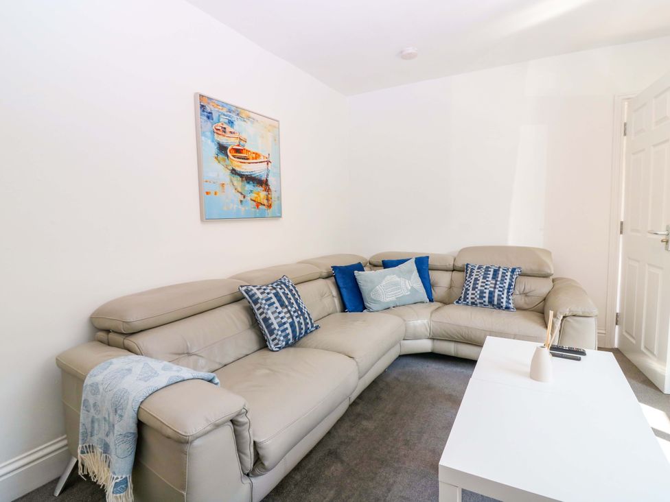 A living room with a sofa and coffee table at No.9 North St in Fraserborough
