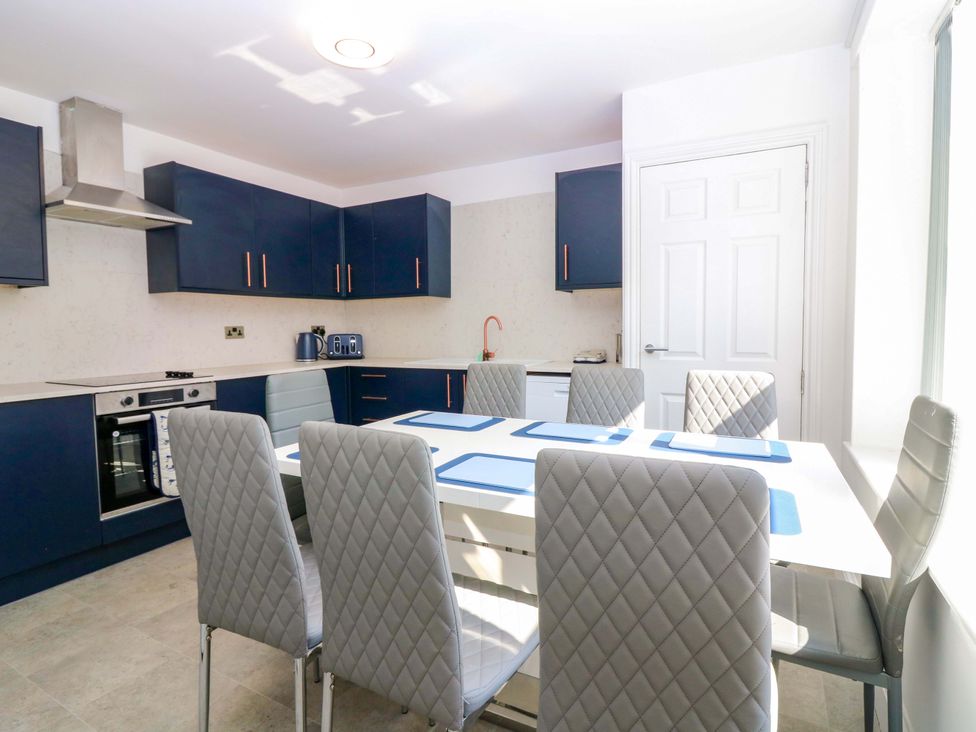 A kitchen with a dining table and chairs at No.9 North St in Fraserborough